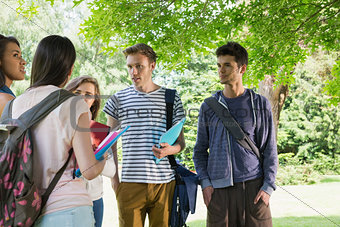 Happy students chatting together outside