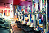 Shiny beer taps in a row