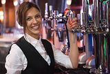 Happy barmaid smiling at camera