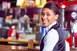 Pretty barmaid smiling at camera
