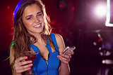 Pretty girl drinking a cocktail and texting