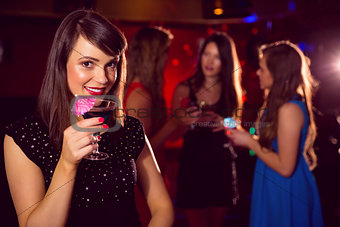 Pretty brunette drinking a cocktail