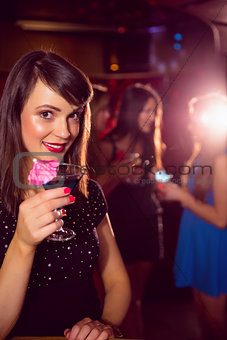 Pretty brunette drinking a cocktail