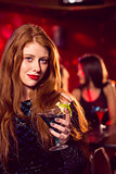 Pretty redhead drinking a cocktail