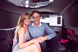 Happy couple smiling in limousine