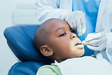 Boy having his teeth examined by dentist