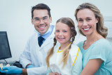 Male dentist with assistant and girl