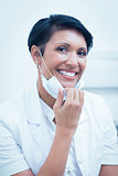 Confident female dentist smiling