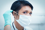 Female dentist wearing surgical mask