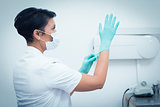 Female dentist wearing surgical glove