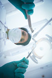 Female dentist in surgical mask holding dental tools