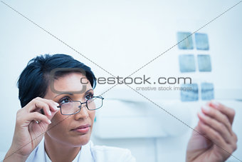 Female dentist looking at x-ray