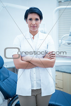 Confident female dentist with arms crossed