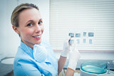 Portrait of female dentist holding x-ray