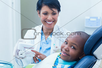 Dentist showing boy prosthesis teeth