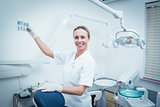 Smiling female dentist looking at x-ray