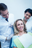 Portrait of dentist with assistant and female patient