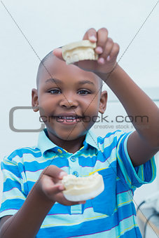 Portrait of boy holding mouth model