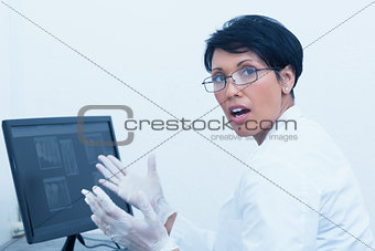 Female dentist with x-ray on computer