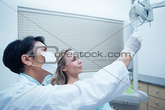 Female dentist showing woman her mouth x-ray