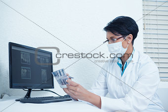 Dentist looking at x-ray by computer