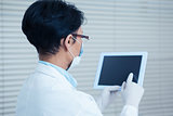 Female dentist using digital tablet