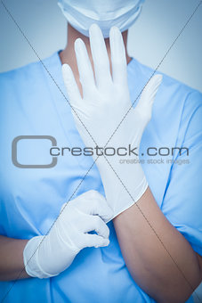 Female dentist wearing surgical glove