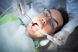 Close up of man having his teeth examined