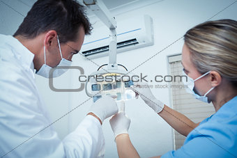Concentrated dentists looking at x-ray