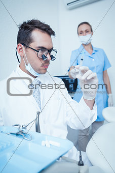 Dentist looking at injection
