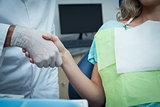 Dentist shaking hands with woman