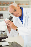 Senior scientist working with microscope