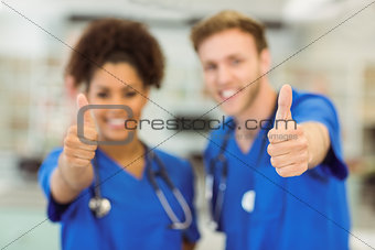 Young medical students showing thumbs up