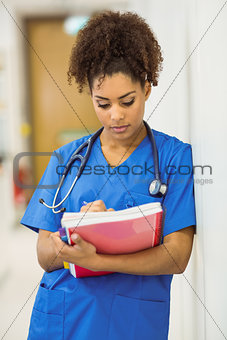 Young medical student taking notes