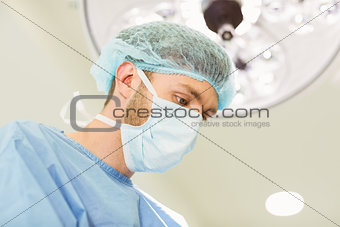 Young surgeon wearing mask and cap