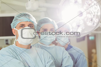 Team of surgeons looking at camera