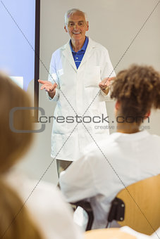 Science professor giving lecture to class