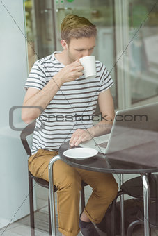 Smiling student drinking hot drink
