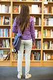 University student standing in the bookcase