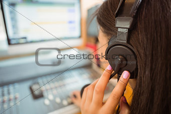 University student mixing audio in a studio