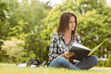 University student sitting reading book