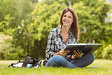 Smiling student sitting and holding a book