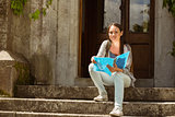 Smiling student sitting and holding book