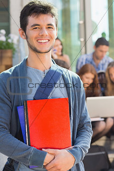 Happy student smiling at camera outside on campus