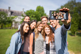 Happy students taking a selfie outside on campus