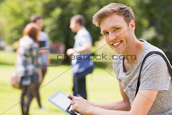 Handsome student studying outside on campus