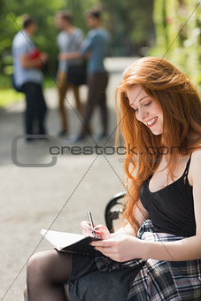 Pretty student studying outside on campus