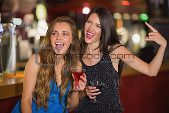 Pretty friends drinking cocktails together