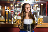 Smiling oktoberfest barmaid with beer