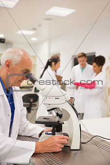 Medical professor working with microscope